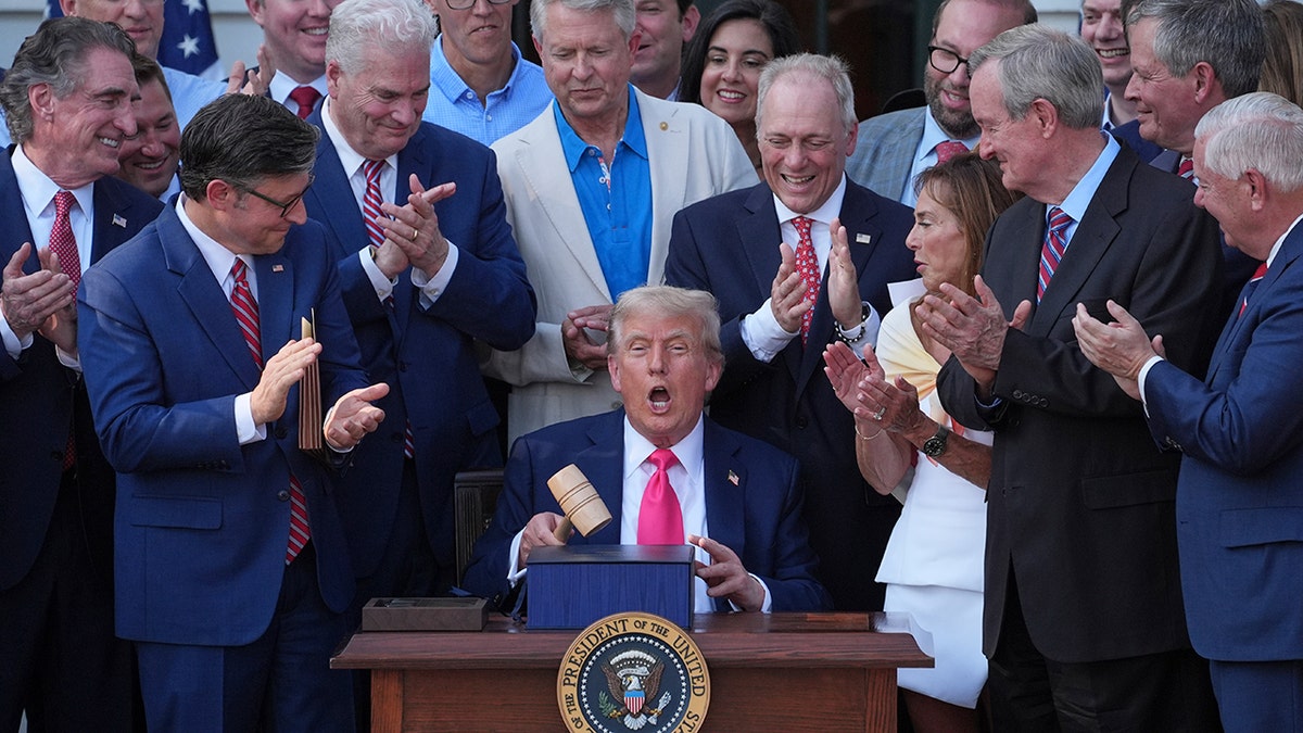 Trump holds gavel handed to him by Johnson