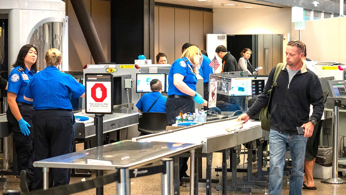 man going through airport TSA
