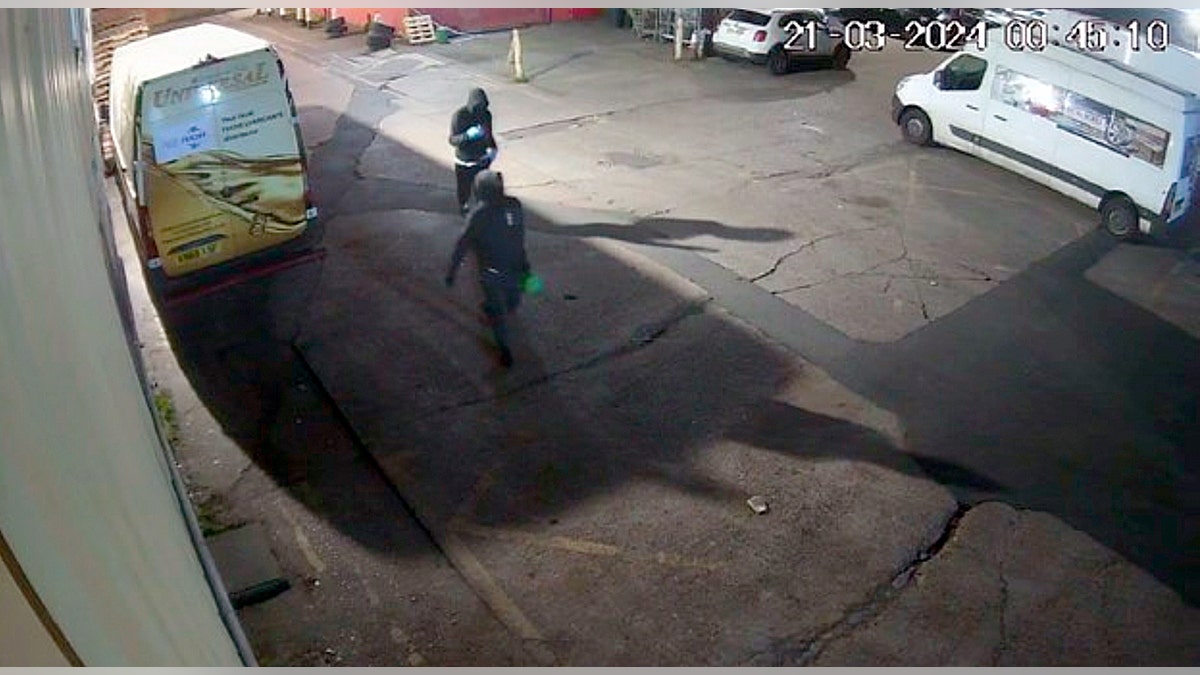 Suveillance footage of 2 hooded men successful a parking