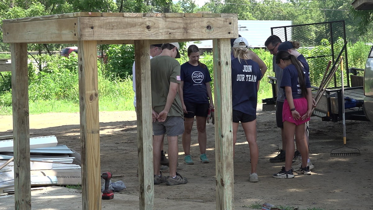 Volunteers from Valley Hope Church praying