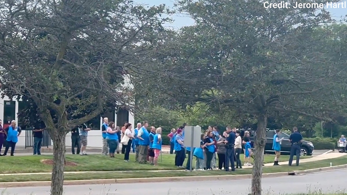 Walmart employees stand outside after a stabbing at the Traverse, Michigan store Saturday afternoon.