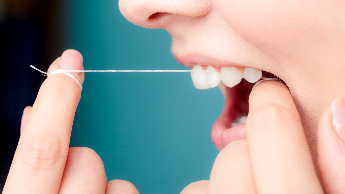 Woman flossing up close