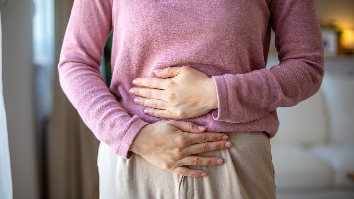 Woman holding gut