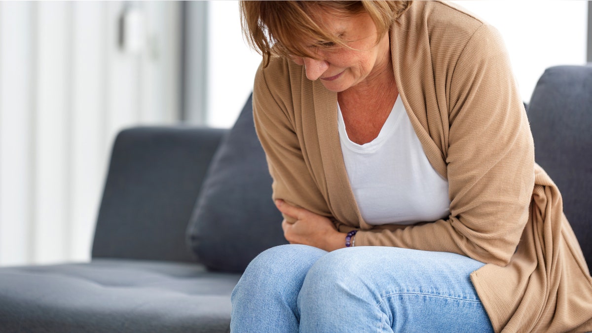 Woman holding stomach