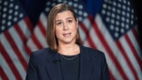Senator Elissa Slotkin with American flags in the background