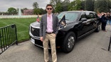 Eric Tarpinian-Jachym standing in front of a car