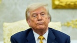 Trump in the Oval Office with a serious face