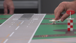A trainee learns to manage aircraft movements via table top exercises.