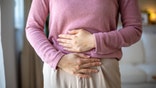 Woman holding gut