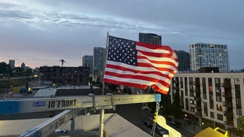 Patriotic ICE officer replaces American flag after protesters burned existing banner at Portland facility