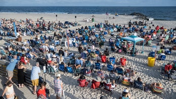 Popular beach town brings Sunday Mass to shore so faithful don't miss sermon or surf