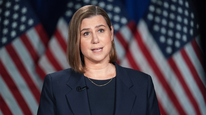 Senator Elissa Slotkin with American flags in the background