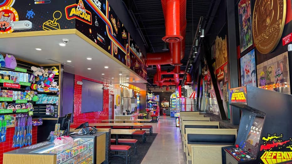 view of chuck's arcade with benches and seats near merchandise center