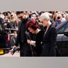 Sharon Osbourne crying at Ozzy Osbourne's funeral, surrounded by children Jack and Kelly