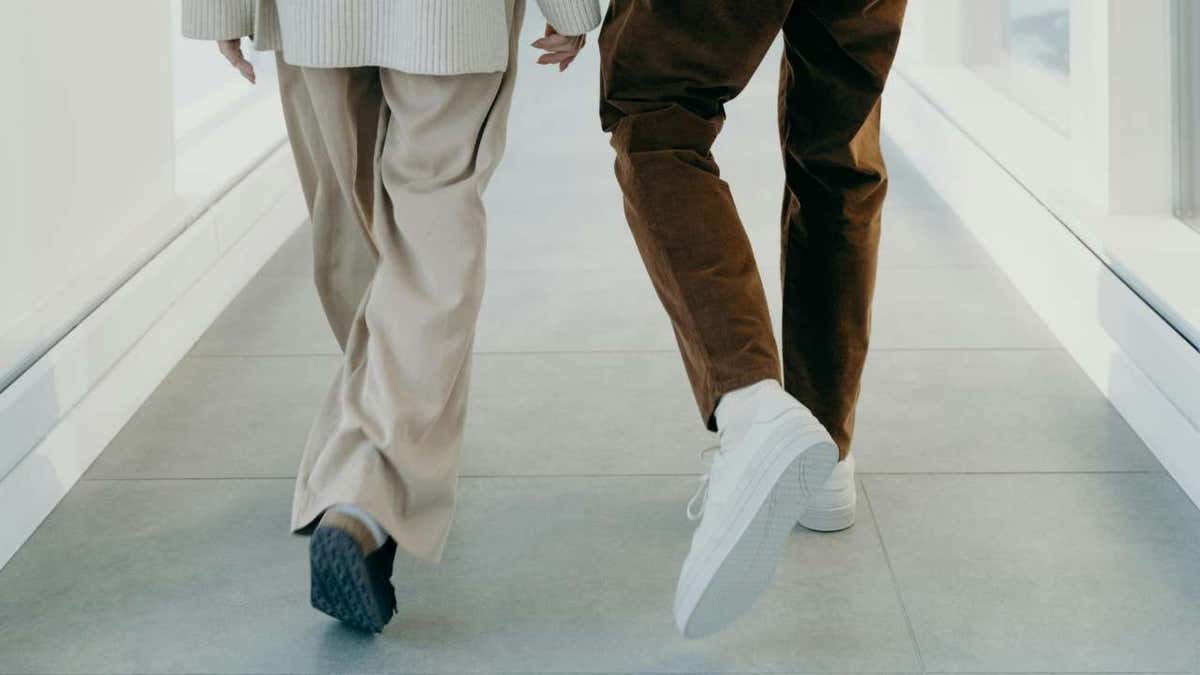 A man and a woman walking indoors