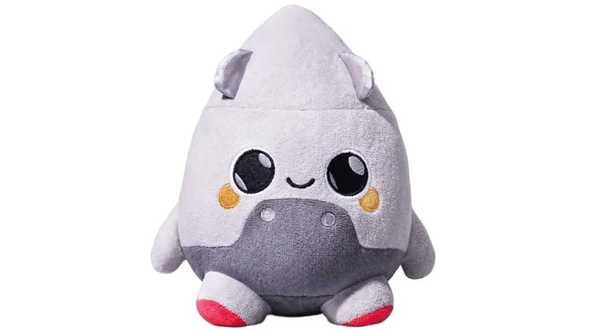 grey cone-shaped, rocket-like smiling stuffed animal