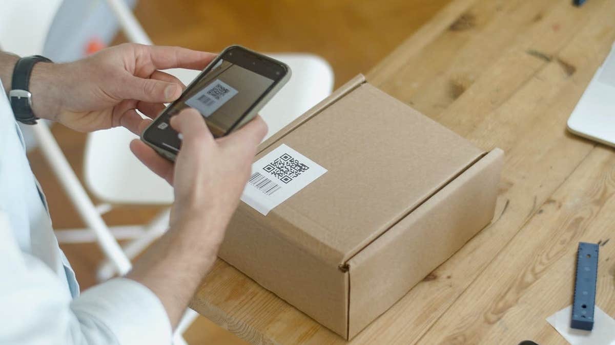 Scanning a QR code on a package with a phone.