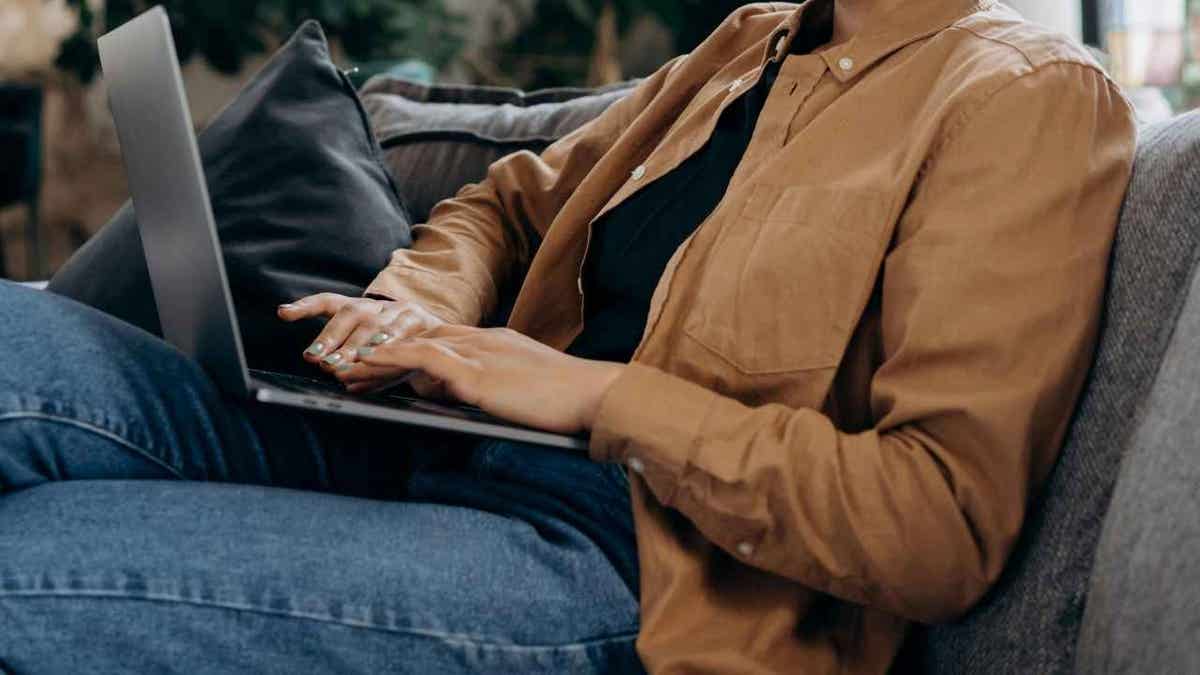 A woman using AI on her laptop.