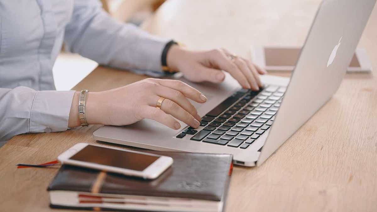 A woman booking airline travel on her laptop (Kurt "CyberGuy" Knutsson)