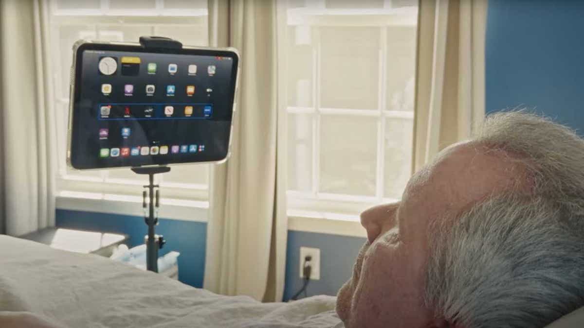 A man with ALS uses Synchron's brain-computer interface to operate an iPad.