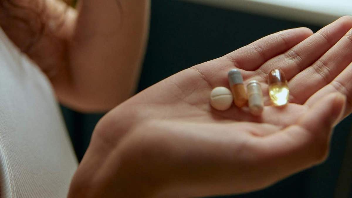 A woman taking pills