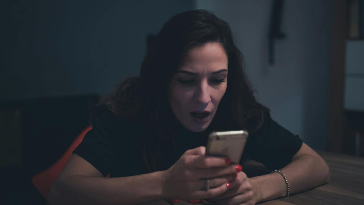 A woman using an app on her smartphone.