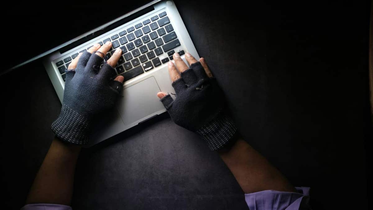 hacker wearing globes and using laptop