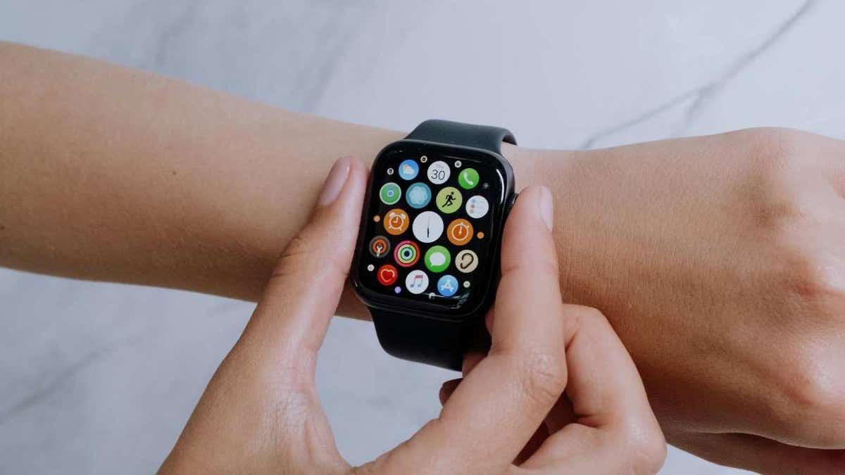 A woman adjusting her Apple Watch