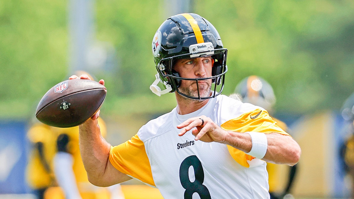 Aaron Rodgers throws football at practice