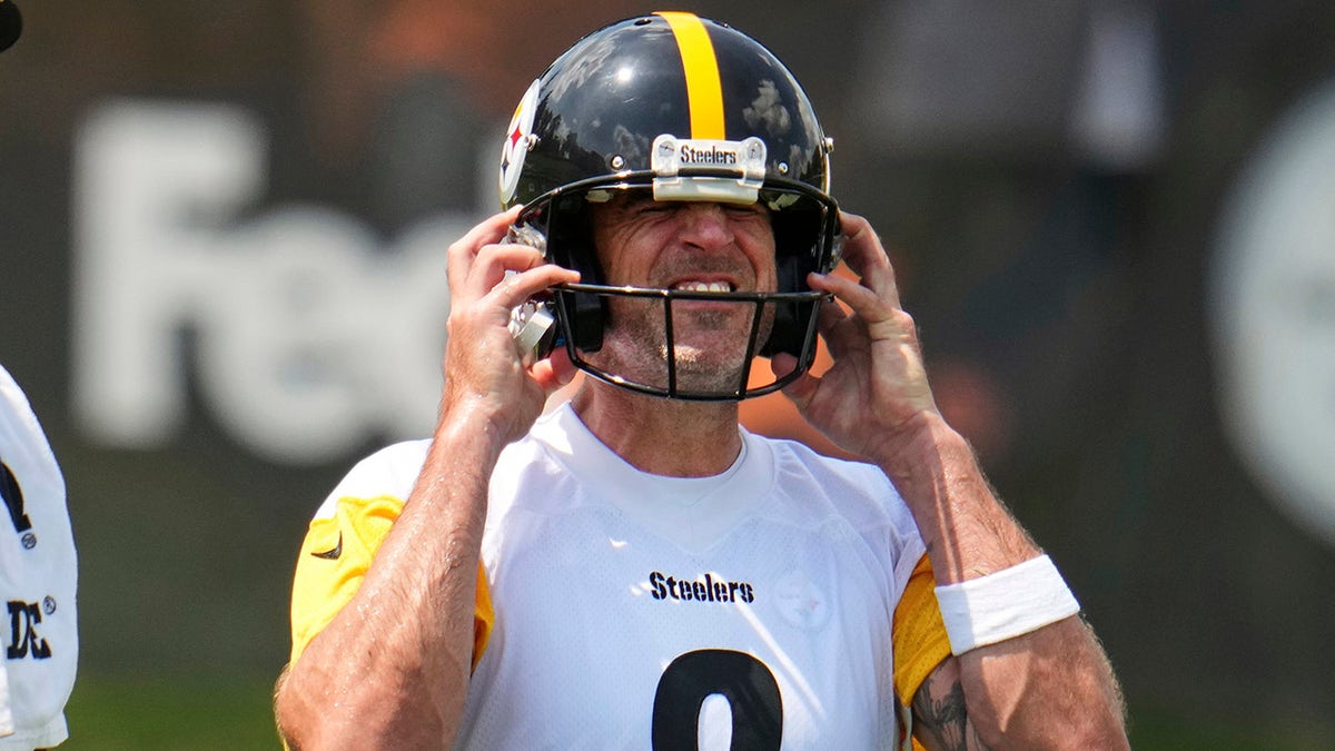 Aaron Rogers wears a helmet