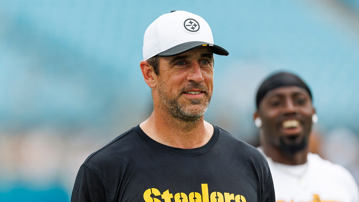 Aaron Rodgers looks on before game