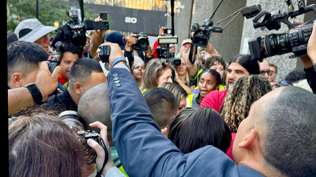 Kilmar Abrego Garcia surrounded by reporters and media