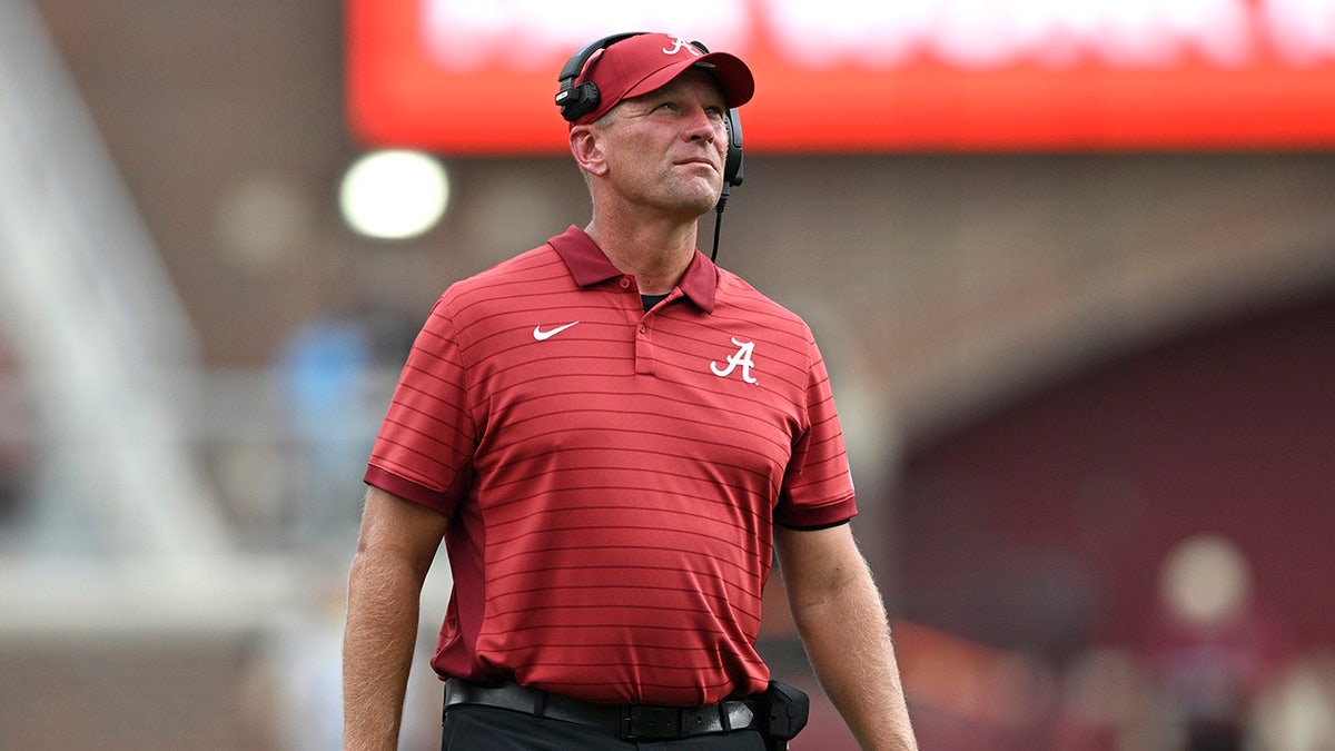 Kalen DeBoer coaches a college football game