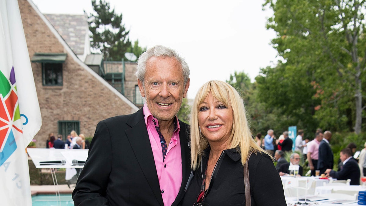 Alan Hamel and Suzanne Somers looking happy in matching black attire before her death from breast cancer.
