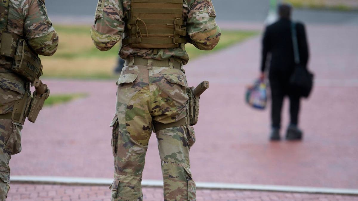Close-up of South Carolina National Guard troops with holstered pistols on patrol in Washington, D.C.