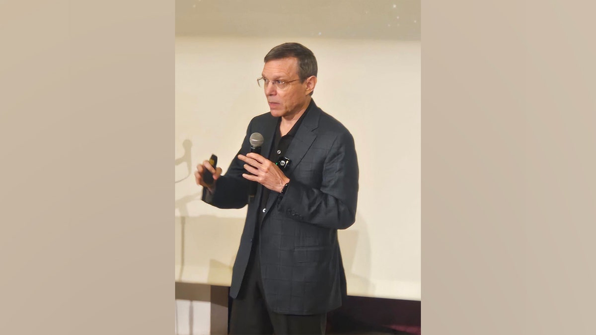Avi Loeb speaking into a microphone