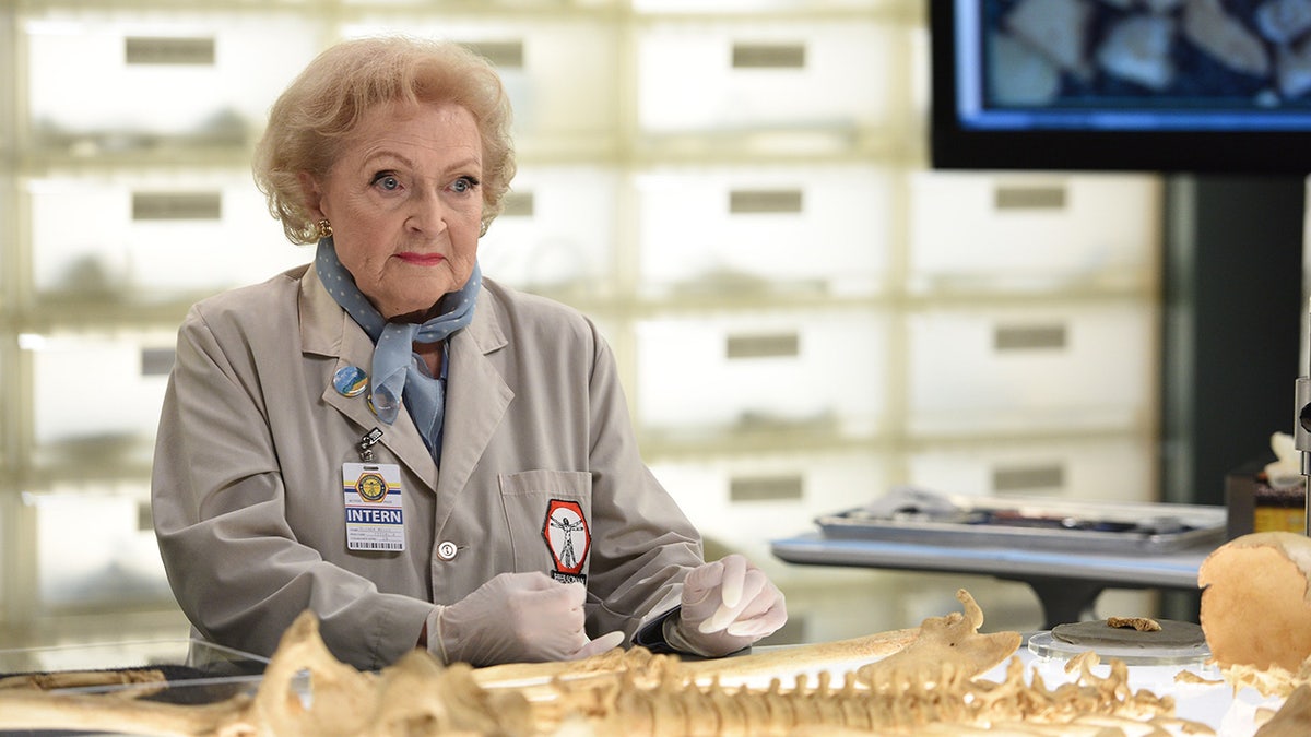 Betty White wears a lab coat on Bones