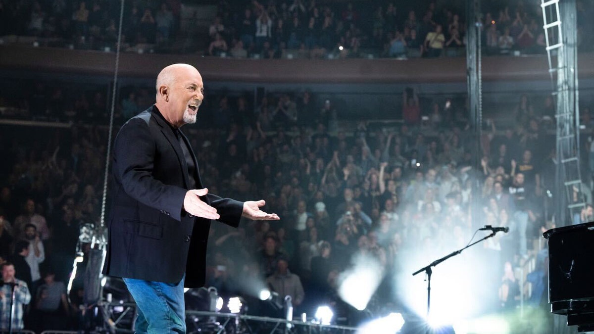 Billy Joel performing onstage.