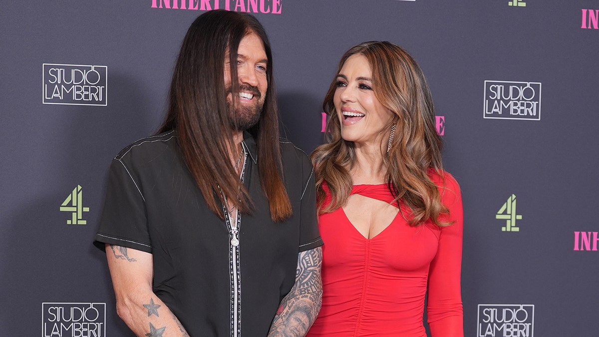 Billy Ray Cyrus and Elizabeth Hurley at the premiere of "The Inheritance" in August 2025.