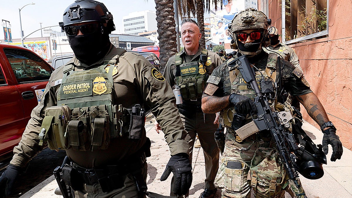 El Centro Sector Chief Patrol Agent Gregory Bovino marches with federal agents after a Border Patrol show of force outside Gov. Gavin Newsom’s Los Angeles press event.