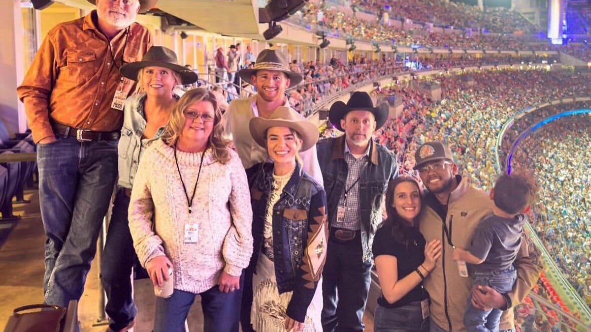 Brandon Blackstock with his family inside the rodeo arena.