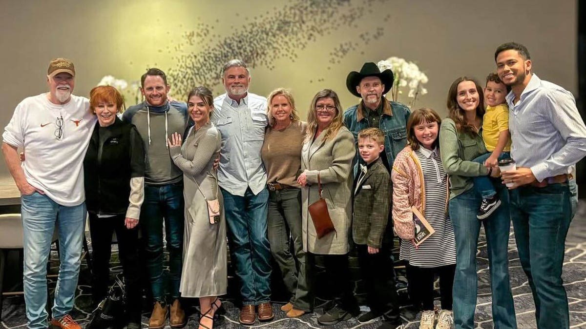 A group shot of Reba McEntire and Brandon Blackstock with their family.