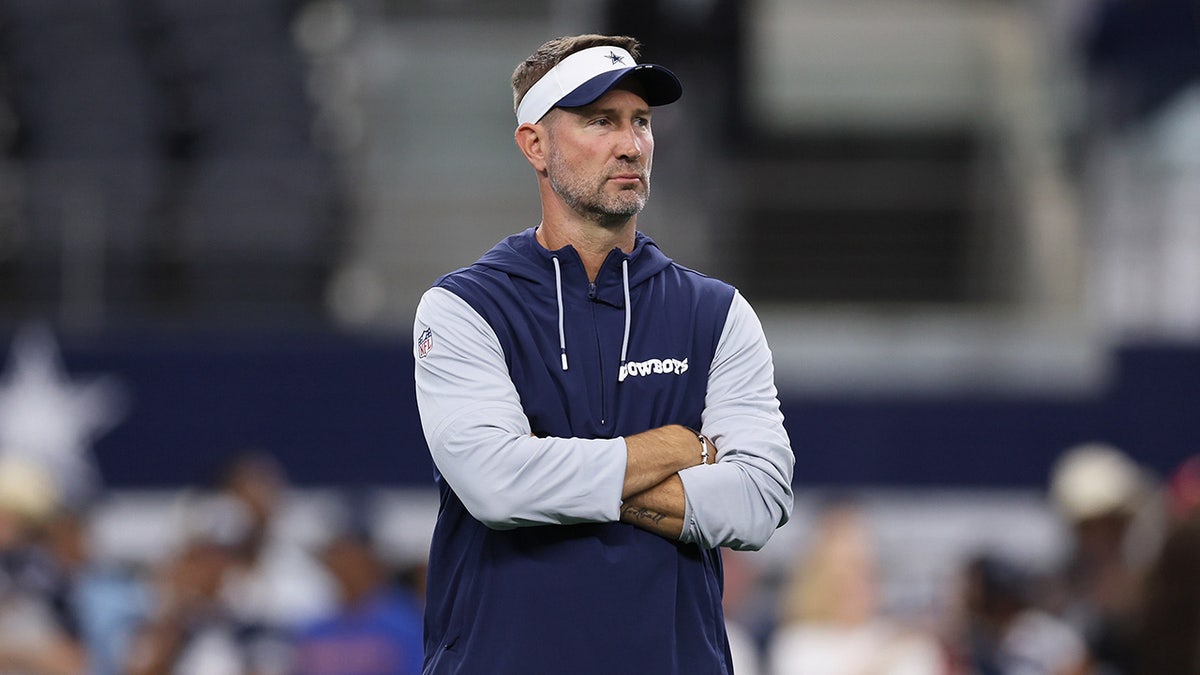 Brian Schottenheimer looks on field