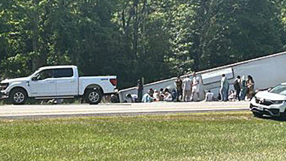 Passengers were seen standing near the bus following the crash.