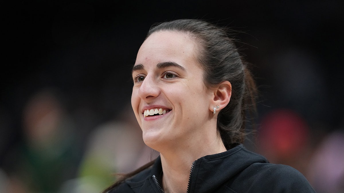Caitlin Clark smiles before a game