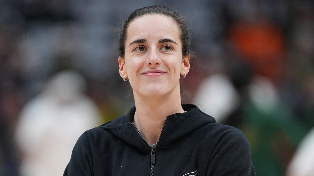 Caitlin Clark looks on before a WNBA game