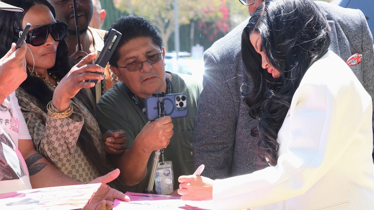 Cardi B signs autographs outside courthouse