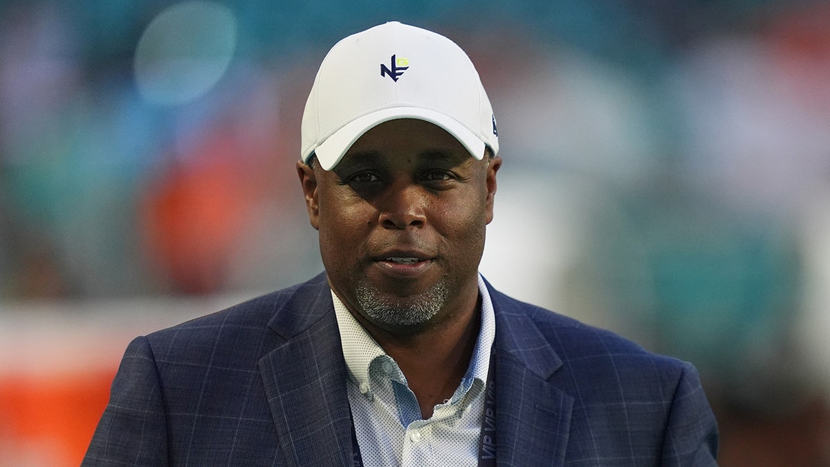 Chris Grier walks on the football field