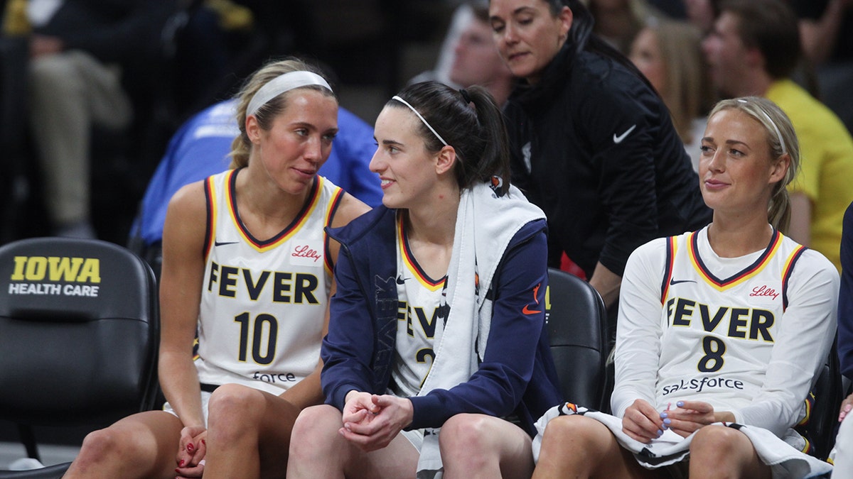Lexie Hull, Caitlin Clark, and Sophie Cunningham on bench