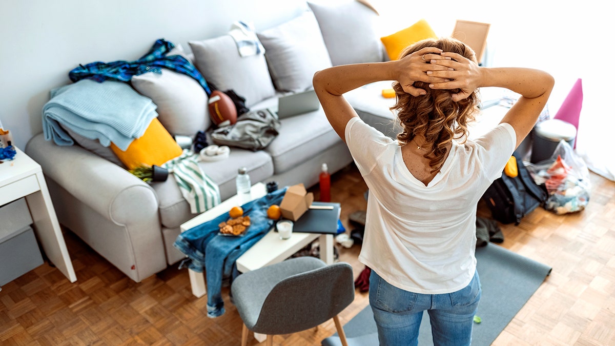 Woman standing while preparing for cleaning at home.